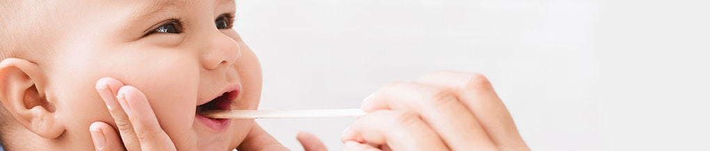 Checking baby teeth for signs of good oral health.