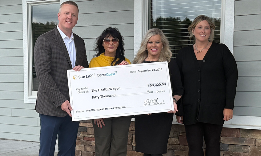 Tim Whited of Sun Life/DentaQuest delivers a check for $50,000 to Health Wagon representatives Dr. Paula Hill-Collins, Dr. Teresa Owens Tyson and Dr. Jen Hammons. The grant will be used to fund oral hygiene and diabetes management.