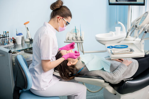 Dentist applying dental sealant