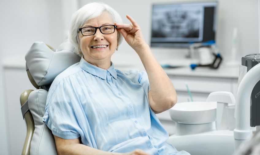 elderly woman wearing glasses and smiling