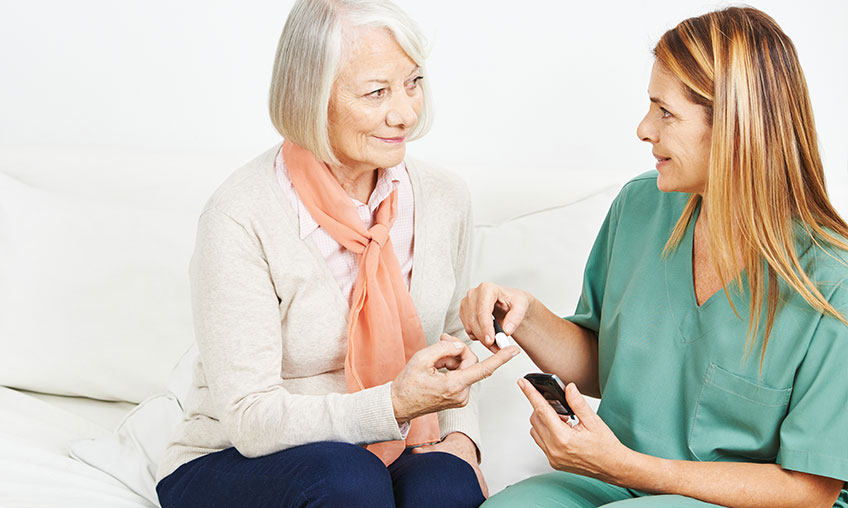 woman with diabetes getting checked by nurse