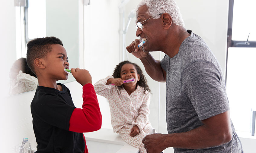 family brushing teeth together