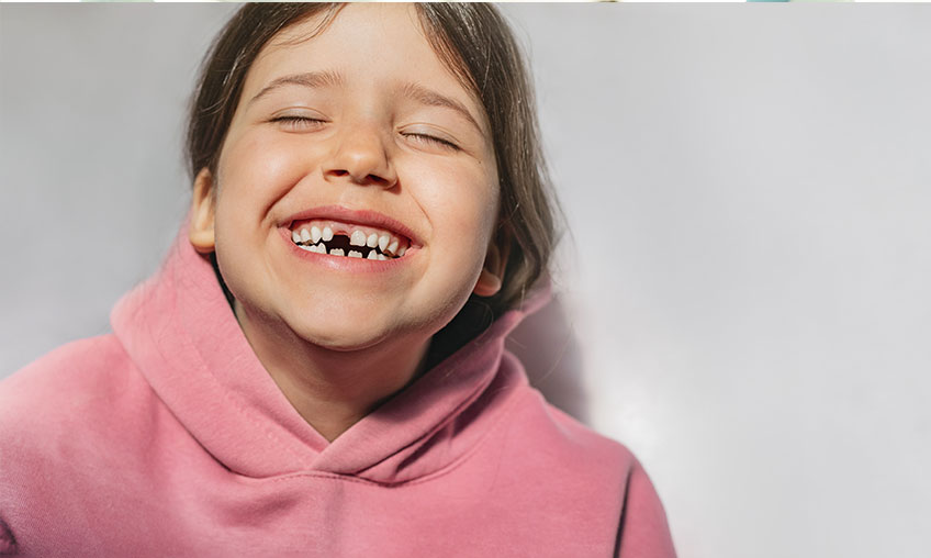 little girl smiling after losing tooth