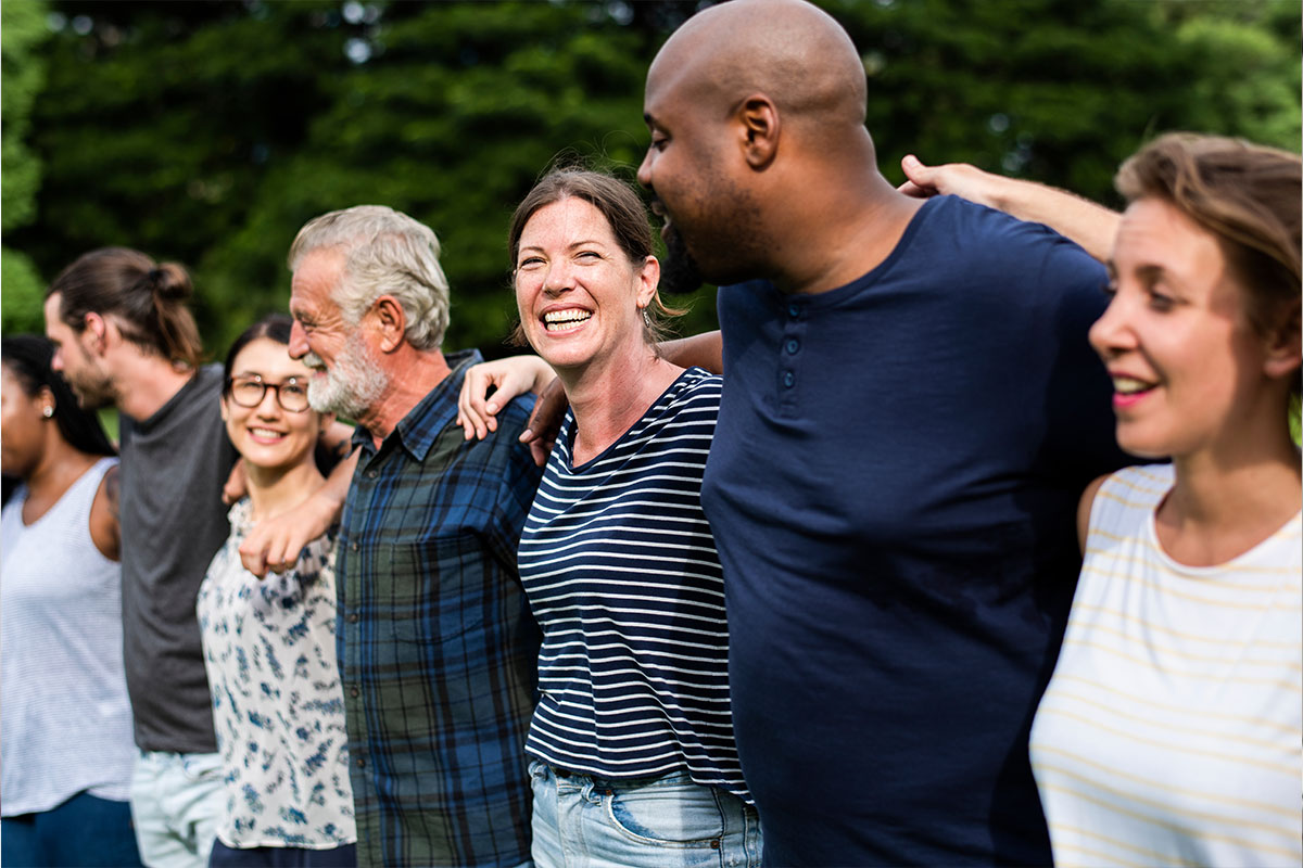 community of people arms around each other