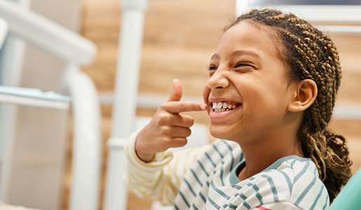 Girl happily examining her smile