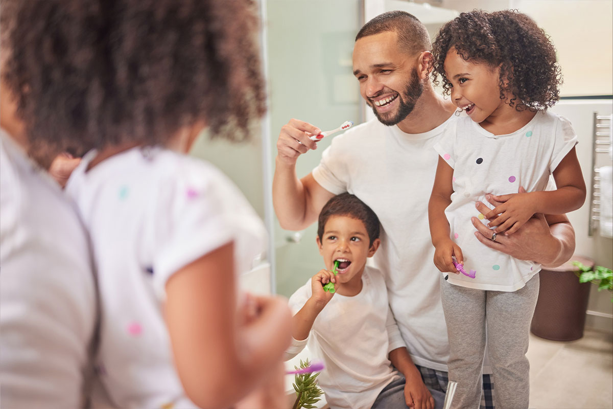 Family brushing their teeth together