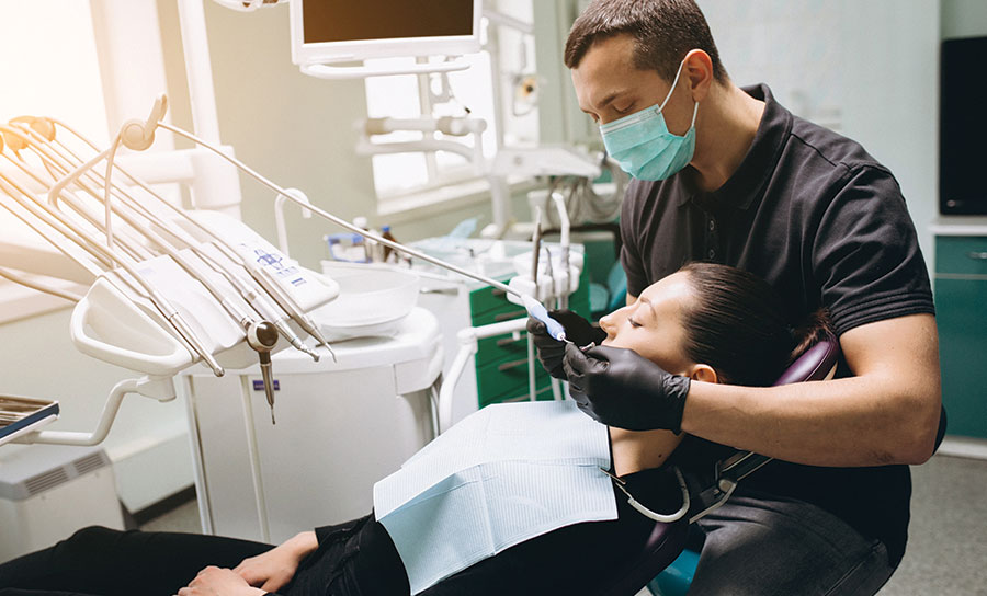 Dental provider during a teeth cleaning session