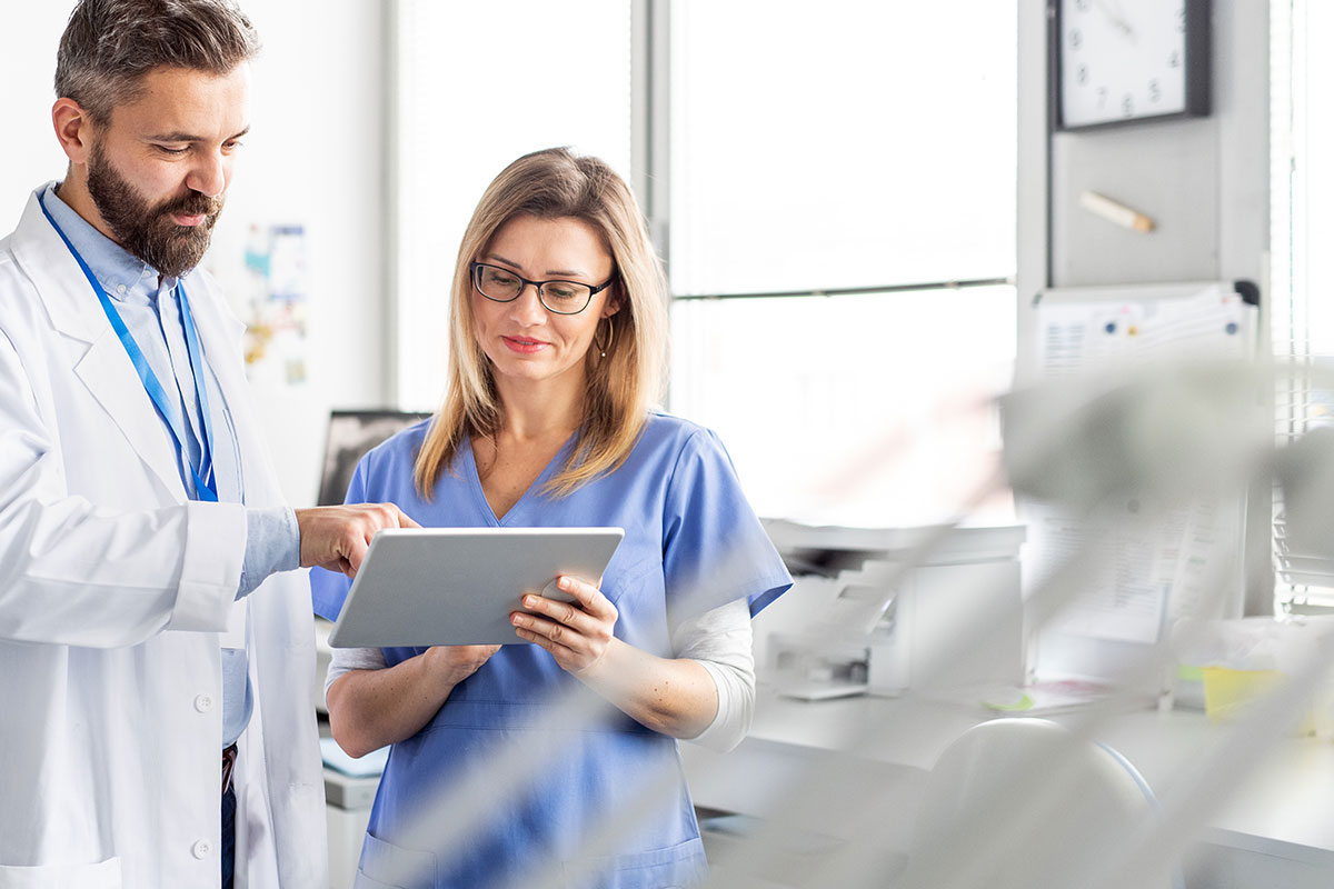 Dental providers using a tablet