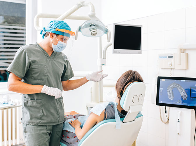 dentist explaining care to female patient